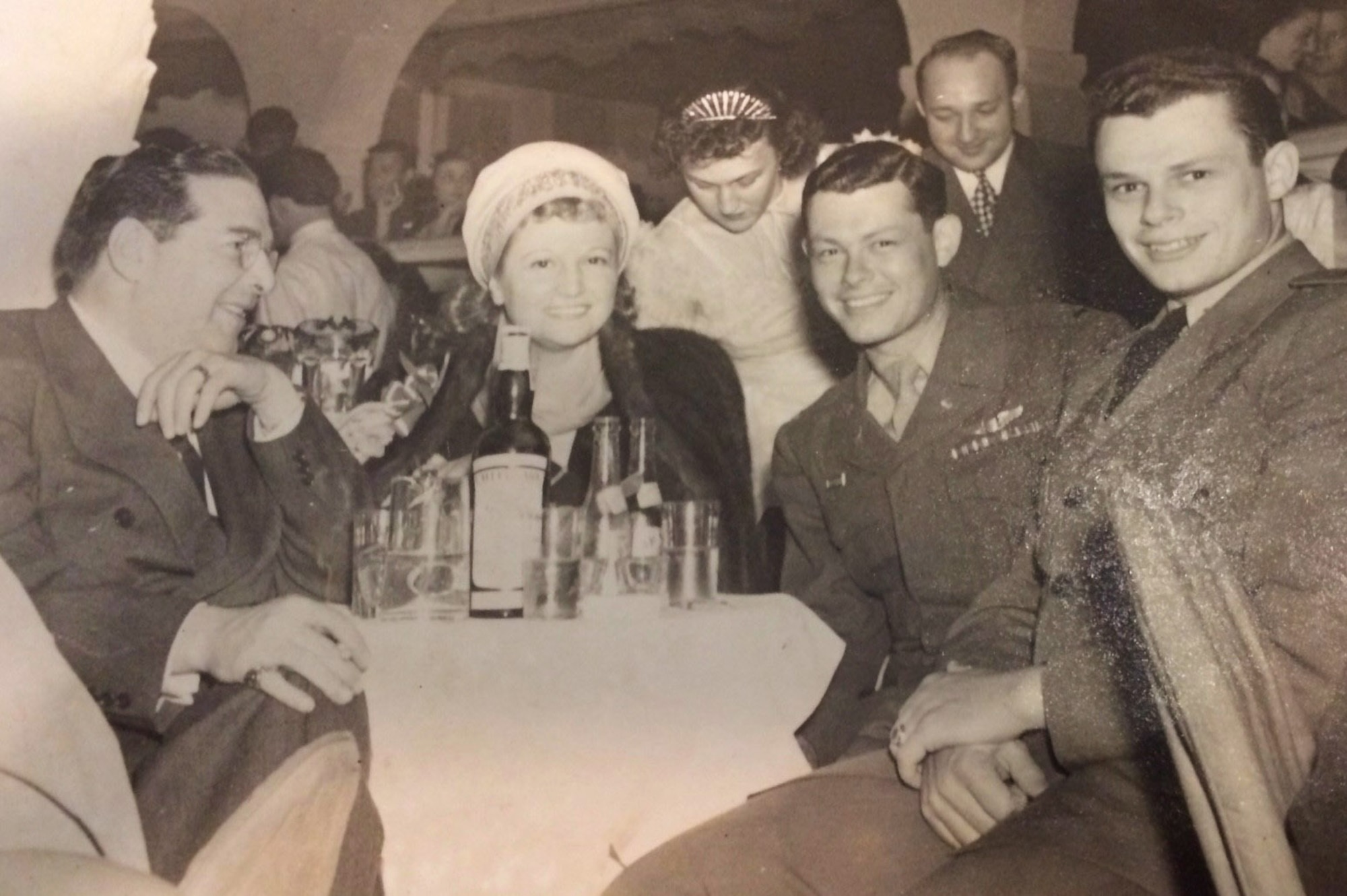 U.S. Army Air Forces 1st Lt. Robert “Bob” Wolff, second right, his brother Allan, right, and Archie Mayo, left, film director and friend of Bob Wolff’s father, celebrate at a nightclub in New York after Bob returned to the States after the end of World War II, June 5, 1945. He was a B-17 Flying Fortress pilot with the 100th Bomb Group, Thorpe Abbotts, England, and was kept as a prisoner-of-war at Stalag Luft III, Germany, for approximately 18 months. (Photo courtesy of Nancy Phelps and Bob Wolff)