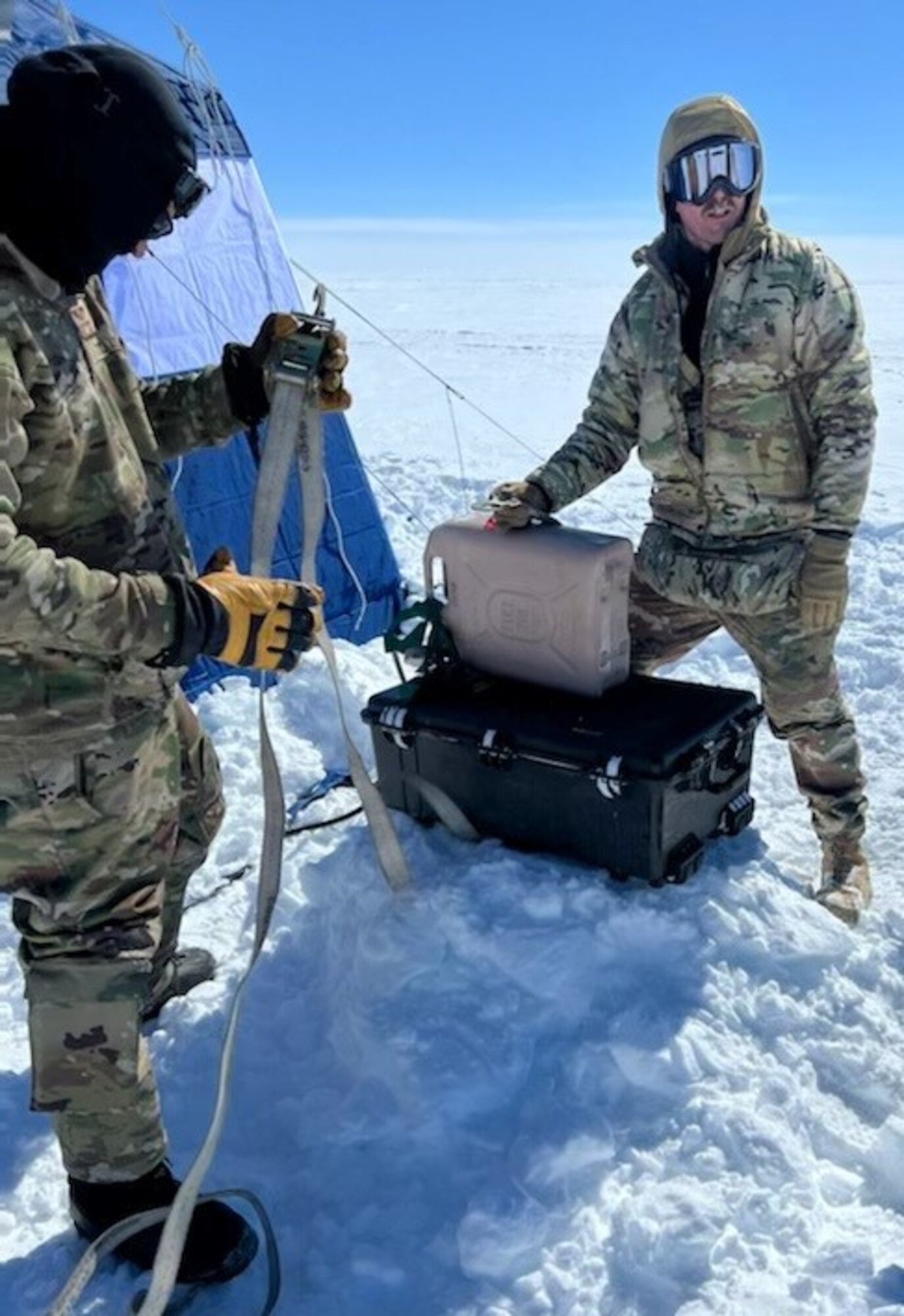 U.S. Air Force Senior Master Sgt. Jeremiah Wickenhauser, right, Superintendent of 133rd Contingency Response Flight, helps set up fuel for a camp heater in Kangerlussuaq, Greenland, May 15, 2022.