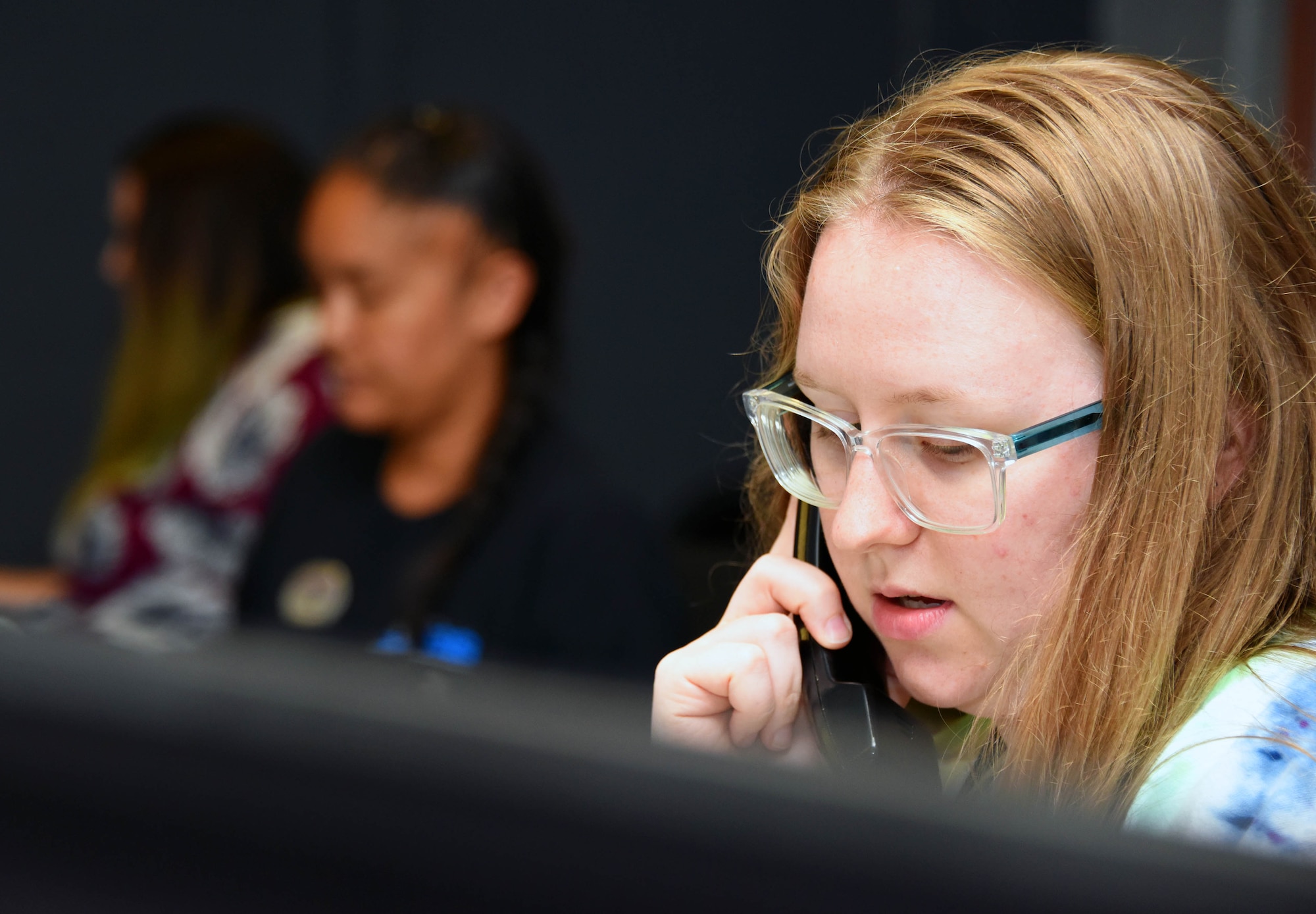 A recreational assistant helps a customer on the phone, pertaining to a booking request.