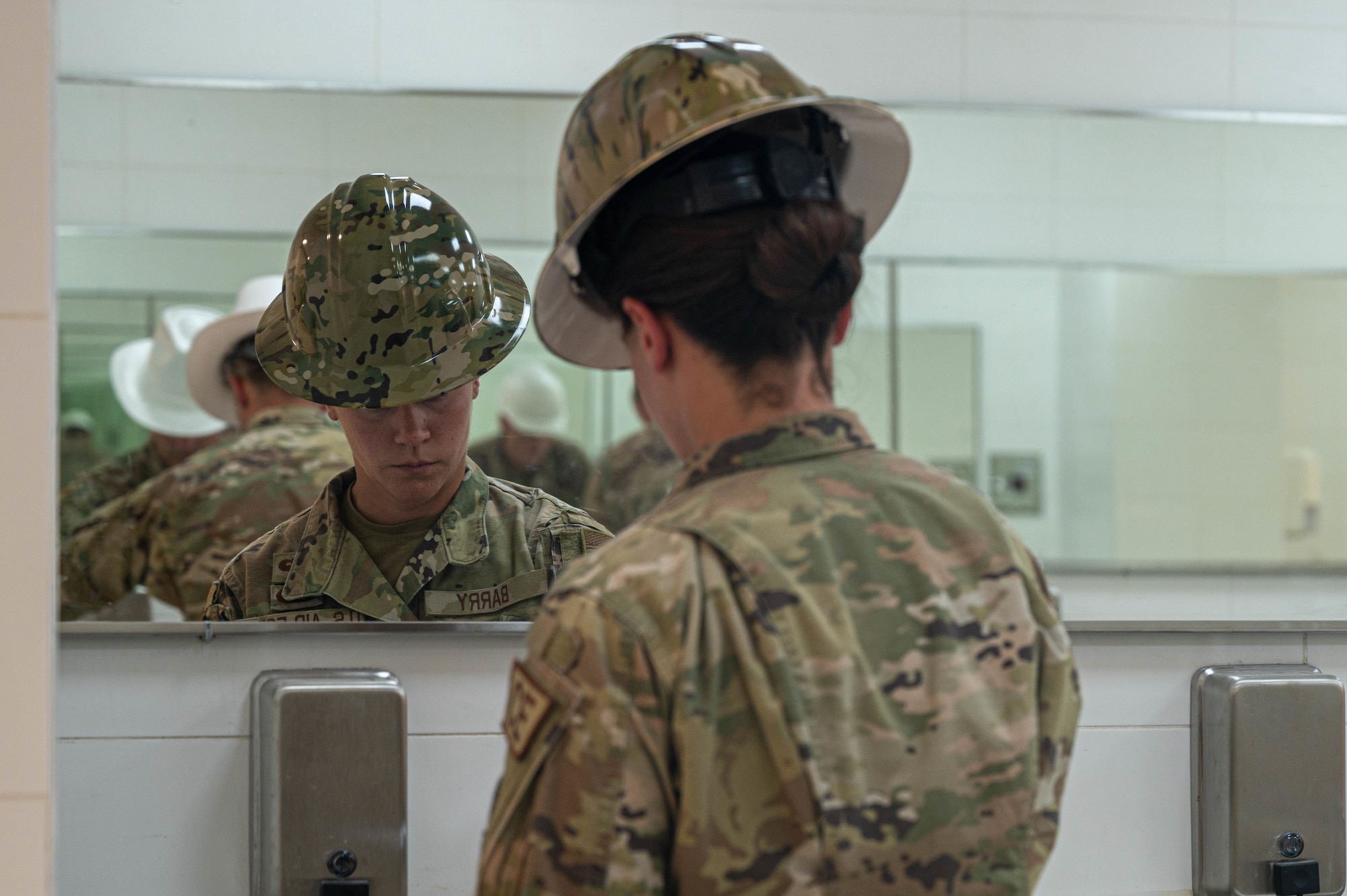 U.S. Air Force Capt. Kaitlyn Barry, 386th Expeditionary Civil Engineer Squadron, inspects the sinks of the renovated dining facility at Ali Al Salem Air Base, Kuwait, May 20, 2022. The facility’s fire suppression was improved and showcases an enduring presence on base as service members move from the expeditionary dining facility. (U.S. Air Force photo by Senior Airman Natalie Filzen)