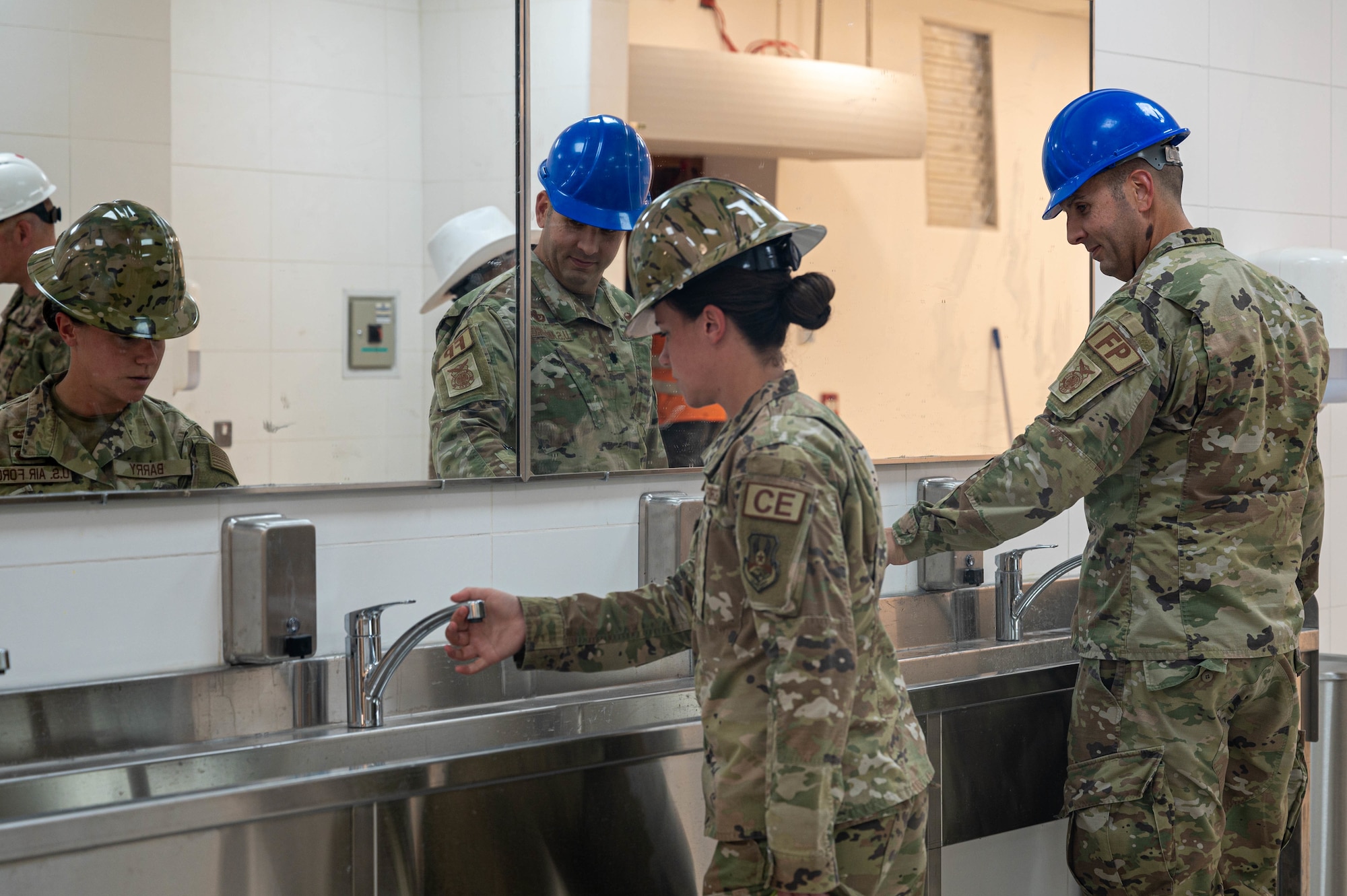 U.S. Air Force Capt. Kaitlyn Barry, left, 386th Expeditionary Civil Engineer Squadron, and Lt. Col. Benjamin Carlson, commander of the 386th ECES, inspect the sinks of the renovated dining facility at Ali Al Salem Air Base, Kuwait, May 20, 2022. The facility’s fire suppression was improved and showcases an enduring presence on base as service members move from the expeditionary dining facility. (U.S. Air Force photo by Senior Airman Natalie Filzen)