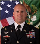 U.S. Army Soldier in dress uniform posed for a professional photo.