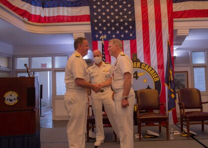 Rear Adm. Jeffery Czerewko, left, relives Rear Adm. Richard Brophy as the commander of Carrier Strike Group (CSG) 4 during a change of command ceremony.