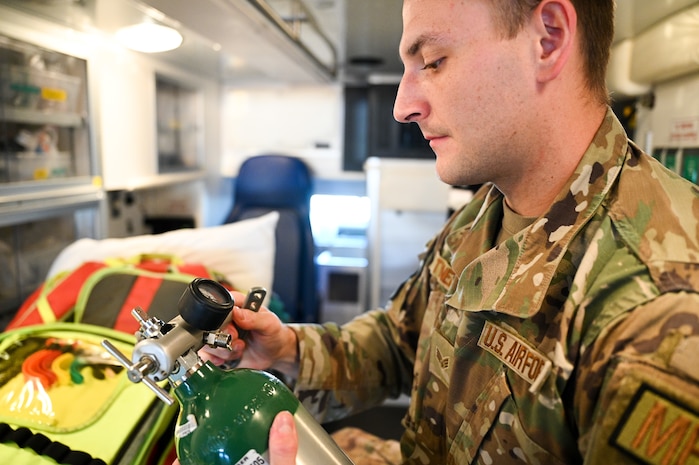 Senior Airman Jacob Tyner, 75th Medical Group, inspects medical supplies aboard an ambulance at Hill Air Force Base, Utah, May 25, 2022. Airmen with the 75th MDG stay mission ready by crewing Hill AFB's ambulance alongside firefighters from the 775th Civil Engineer Squadron's Fire and Emergency Services flight. By providing hands-on emergency and pre-hospital care to patients, medics get the opportunity to use skills the don't use in the base clinic. (U.S. Air Force photo by R. Nial Bradshaw)