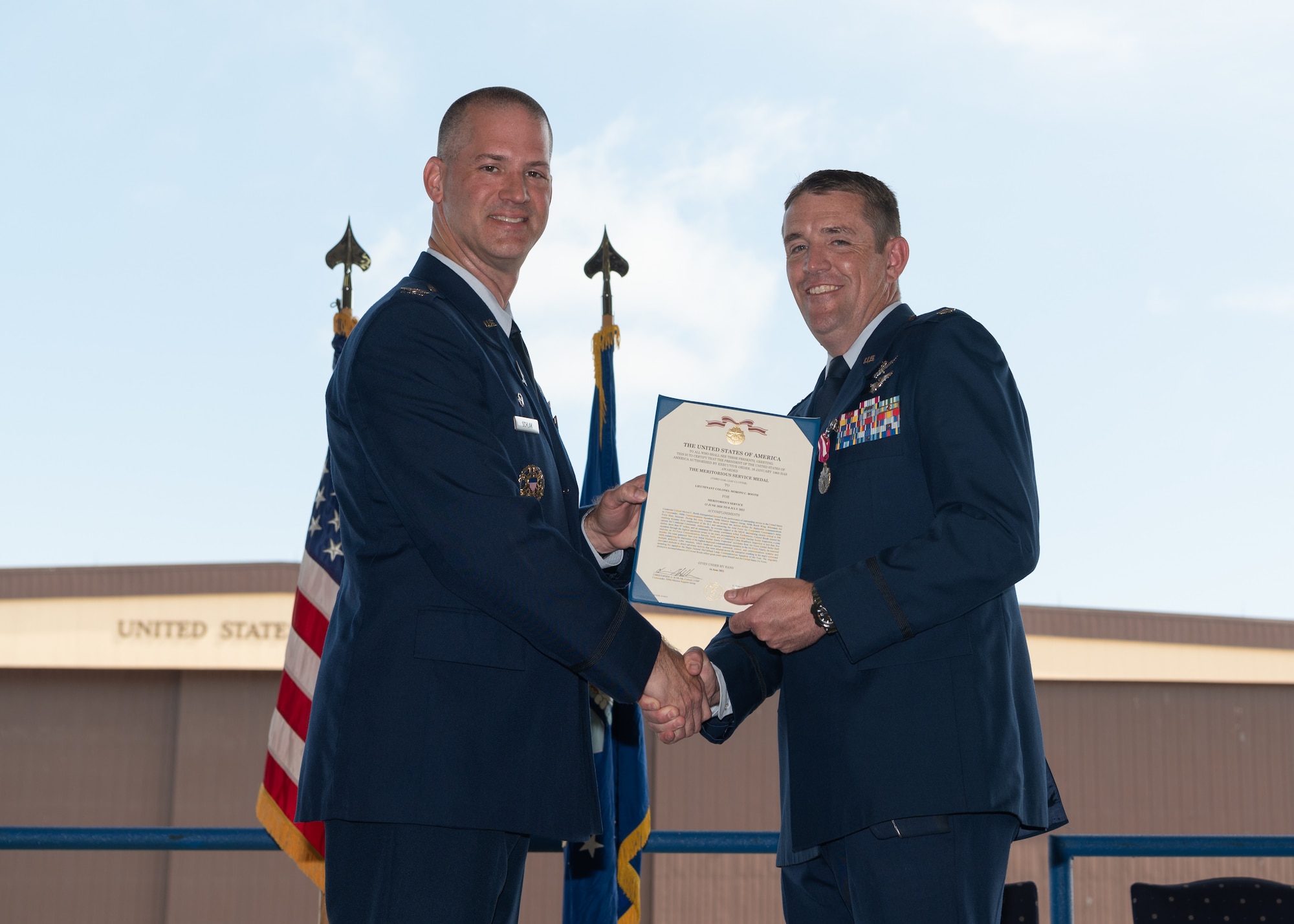Lt. Col. M. Craig Booth receives the Meritorious Service Medal during the 509th Communications Squadron change of command.