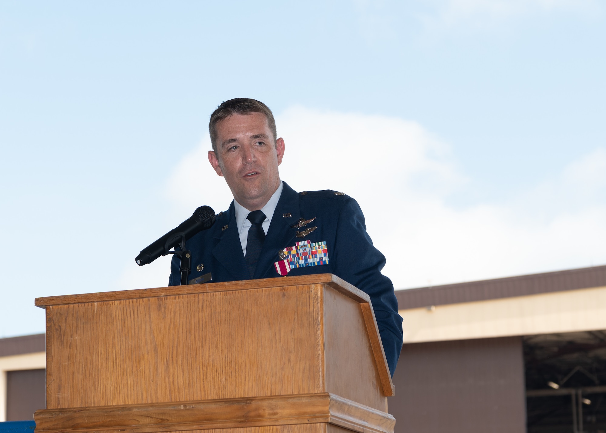 Lt. Col. M. Craig Booth speaks at the podium during the 509th Communications Squadron change of command.