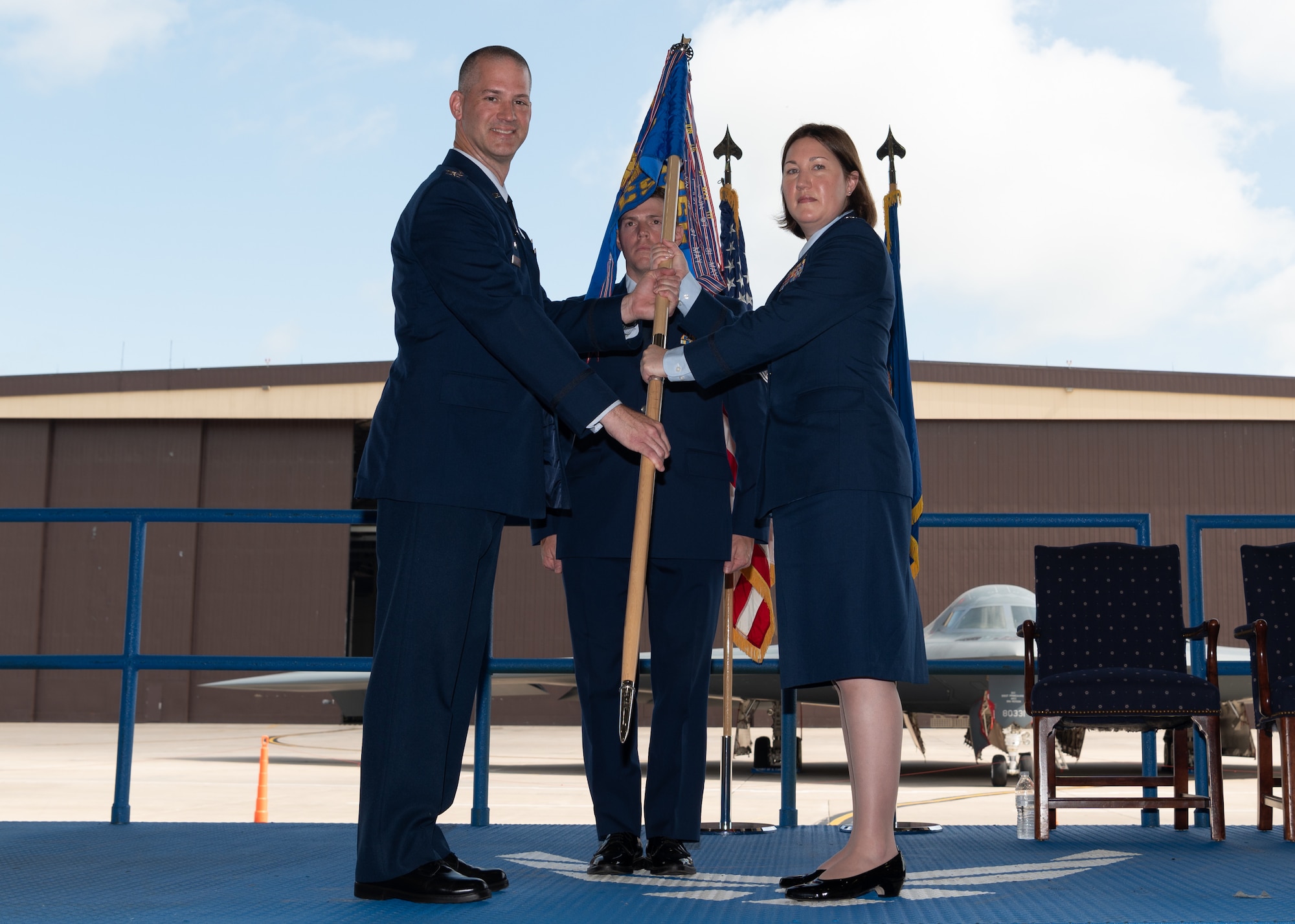 Lt. Col. Heidi Millburg, accepts the 509th Communications Squadron guidon and assumes command from Col. Christopher Schlak.