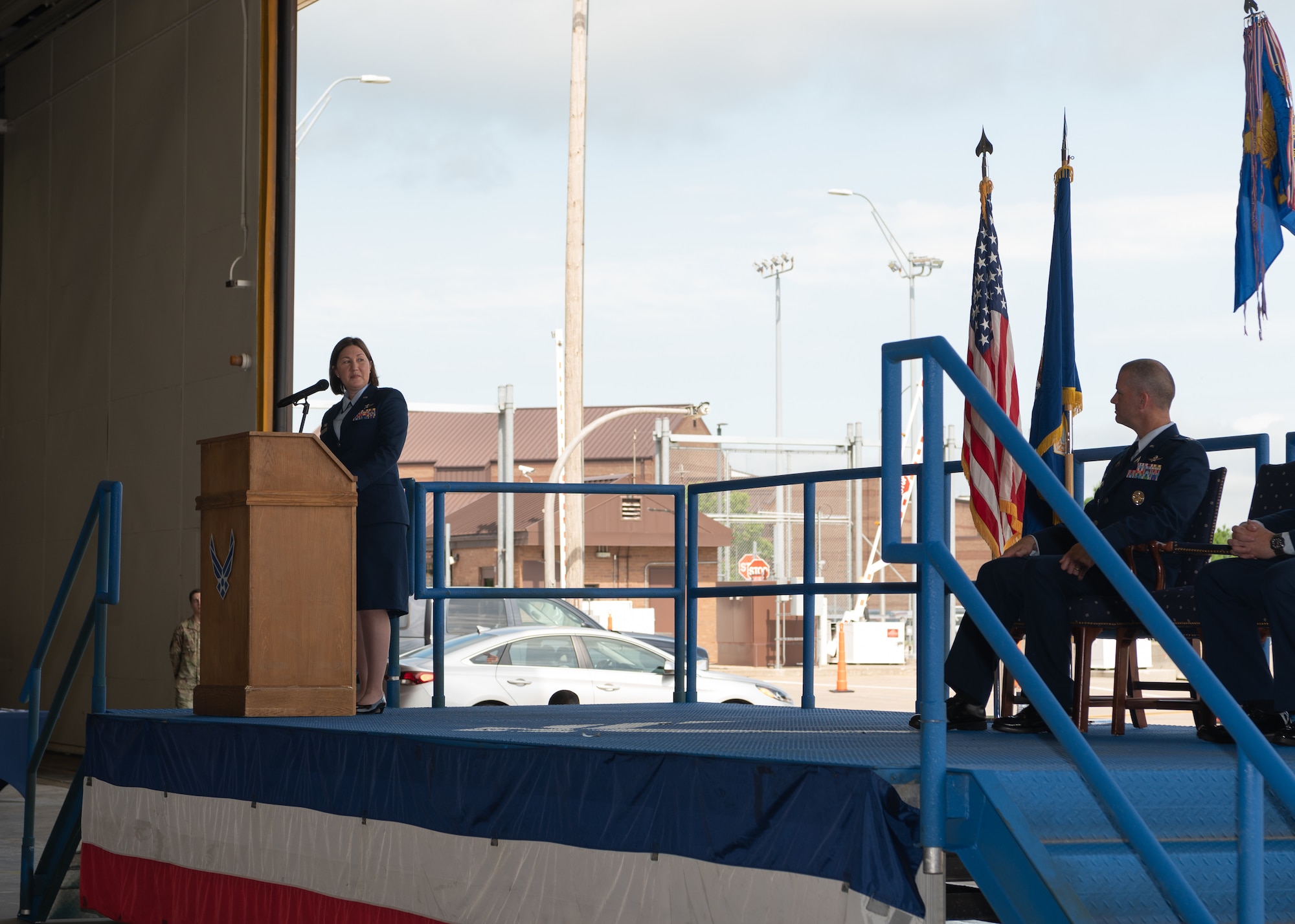Lt. Col. Heidi Millburg speaks at the podium during the 509th Communications Squadron change of command.