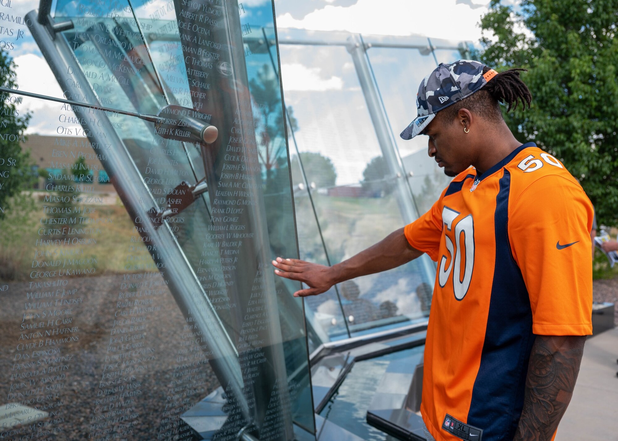 Jonas Griffith, Denver Broncos inside linebacker, observes the names of fallen Colorado veterans at the Colorado Freedom Memorial in Aurora, Colo., July 8, 2022. Members from the Denver Broncos visited Buckley to tour different facilities across base as well as visit the Colorado Freedom Memorial. (U.S. Space Force photo by Senior Airman Haley N. Blevins)