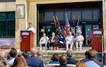 Rear Adm. David Goggins provides remarks during the  Program Executive Office Attack Submarines (PEO SSN) change of command ceremony, held at the Washington Navy Yard, June 30. Rear Adm Jonathan Rucker (left, seated) relieved Rear Adm. David Goggins as PEO SSN.