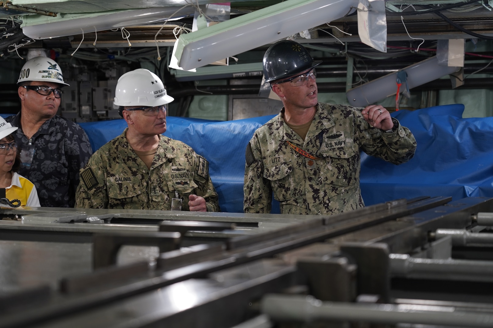 Vice Adm. Bill Galinis, (third from left) Commander of Naval Sea Systems Command (NAVSEA), discusses maintenance projects with Lt. Cmdr. D. Litz (right), Executive Officer, USS Tucson (SSN-770), May 13, 2022.

Galinis along with Ms. Giao Phan, Executive Director for NAVSEA visited Pearl Harbor Naval Shipyard and Intermediate Maintenance Facility to assess the alignment and progress on implementing the U.S. Navy’s Naval Sustainment System – Shipyard (NSS-SY) performance improvement initiatives while conducting a review of shipyard operations in Hawaii. (Official U.S. Navy photo by Marc Ayalin)