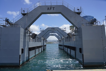 A buoyancy assist module (BAM) sits ominously along the harbor of Pearl Harbor Naval Shipyard and Intermediate Maintenance Facility May 13, 2022. BAMs are used to reduce the draft of ships allowing for easier dry docking. (Official U.S. Navy photo by Marc Ayalin)