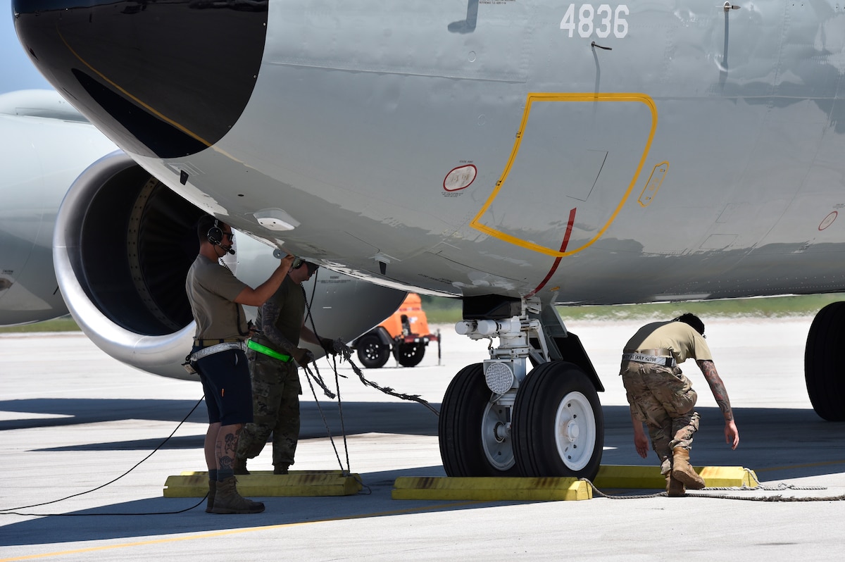 Airmen working under the nose of a WC-135R aircraft