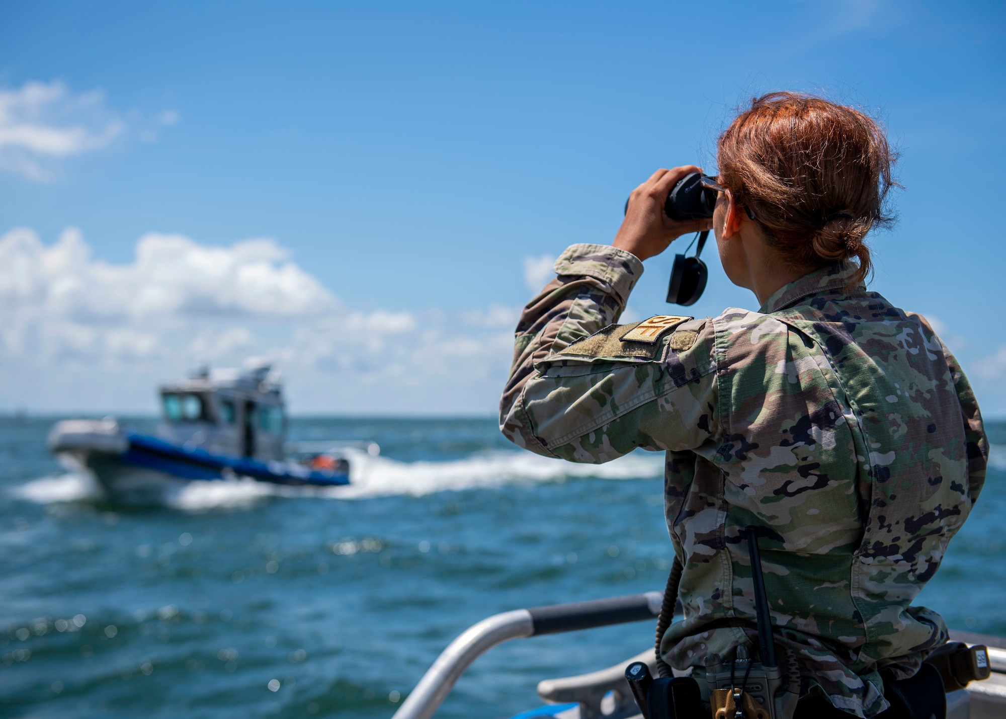 U.S. Air Force Airman 1st Class Samari Rivera-Rodriguez, 6th Security Forces Squadron marine patrolman, scans the waters surrounding MacDill Air Force Base, Florida, July 10, 2022. Marine patrolmen provide waterborne deterrence, detection and respond to any threat within MacDill’s surrounding waters. The 6th SFS marine patrol unit is responsible for one of the largest CRA’s in the Department of Defense and is the only 24/7 unit in the U.S. Air Force. (U.S. Air Force photo by Airman 1st Class Lauren Cobin)