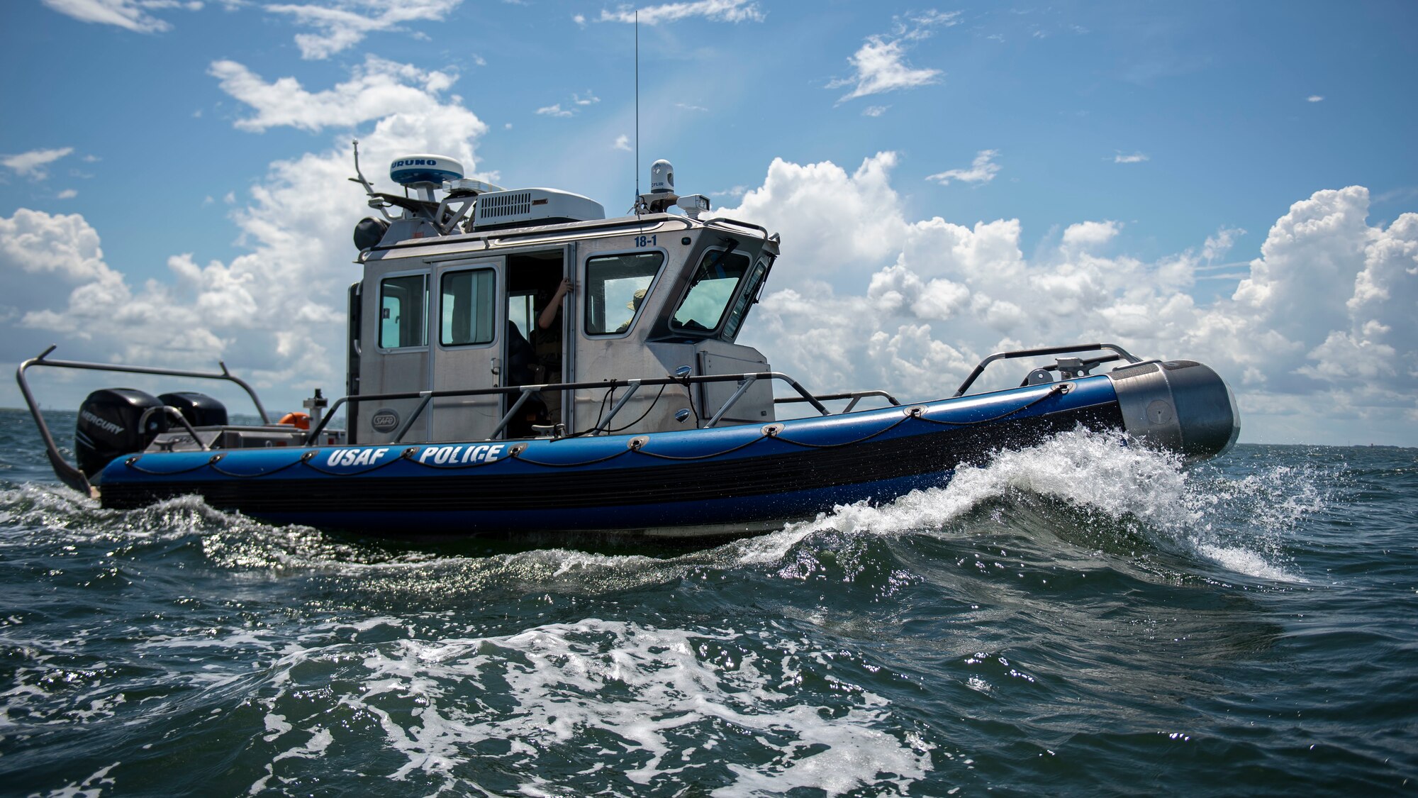 U.S. marine patrolmen assigned to the 6th Security Forces Squadron, operate a vessel while on patrol around MacDill Air Force Base, Florida, July 10, 2022. The primary role of the 6th SFS marine patrol unit is to keep boaters from entering MacDill’s coastal restricted area which extends over one mile outside of base. (U.S. Air Force photo by Airman 1st Class Lauren Cobin)