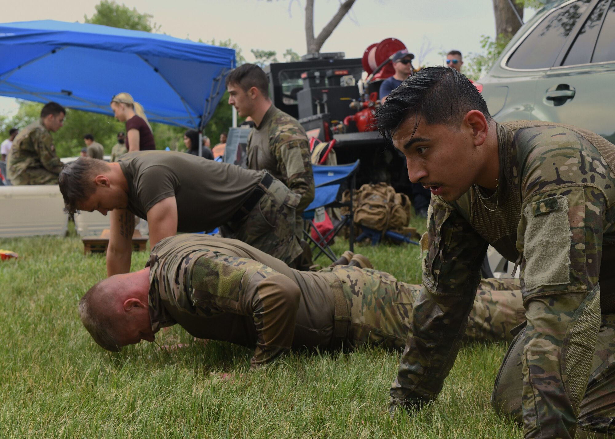 Members with the 90th Security Forces Group perform pushups during the Crow Creek Challenge, July 8th, 2022, at F.E. Warren Air Force Base, Wyo. The crow creek challenge pushed Airmen to test their physical and mental readiness. (U.S. Photo by Senior Airman Darius Frazier.)