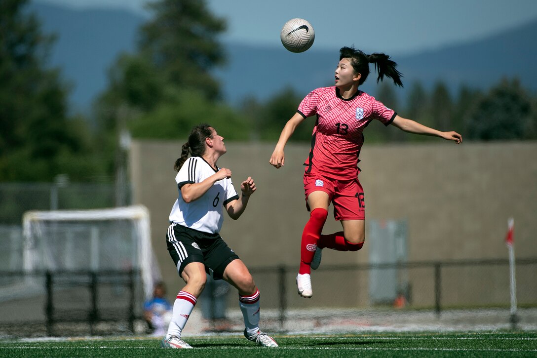Korea's Jeongmin Lee leaps for a header above Canada’s Katie MacAskill during the 13th CISM (International Military Sports Council) World Military Women’s Football Championship in Meade, Washington July 12, 2022. (DoD photo by EJ Hersom)