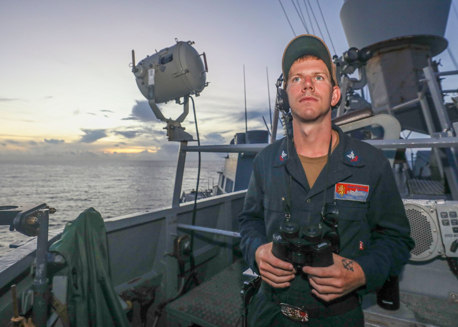 SOUTH CHINA SEA (July 13, 2022) Boatswain’s Mate 2nd Class Daniel Zehder, from Dayton, Ohio, stands lookout watch on the bridgewing as the guided-missile destroyer USS Benfold (DDG 65) conducts routine underway operations. Benfold is forward-deployed to the U.S. 7th Fleet area of operations in support of a free and open Indo-Pacific. (U.S. Navy photo by Mass Communication Specialist 2nd Class Arthur Rosen)