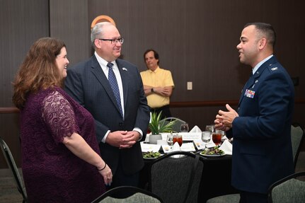 Col. Luis Berrios, 433rd Aerospace Medicine Squadron commander, talks with Sean Grindall, United Services Automobile Association vice president, and his guest during the 433rd Airlift Wing Honorary Commanders’ Induction Ceremony in San Antonio, July 9, 2022. Each honorary commander was paired with unit leaders to learn a unit’s mission and purpose. (U.S. Air Force photo by Senior Airman Brittany Wich)