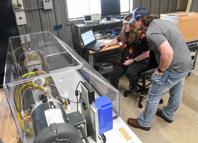 Parke Nation, left, an Arnold Engineering Development Complex mechanical reliability engineer, explains to Ethan Holcomb, an AEDC mechanical engineering intern with one of the contractors for Arnold Engineering Development Complex, about the Condition-Based Maintenance Fault Simulator that was added to the Innovation Center for condition-based maintenance training, June 8, 2022, at Arnold Air Force Base, Tennessee. (U.S. Air Force photo by Jill Pickett)