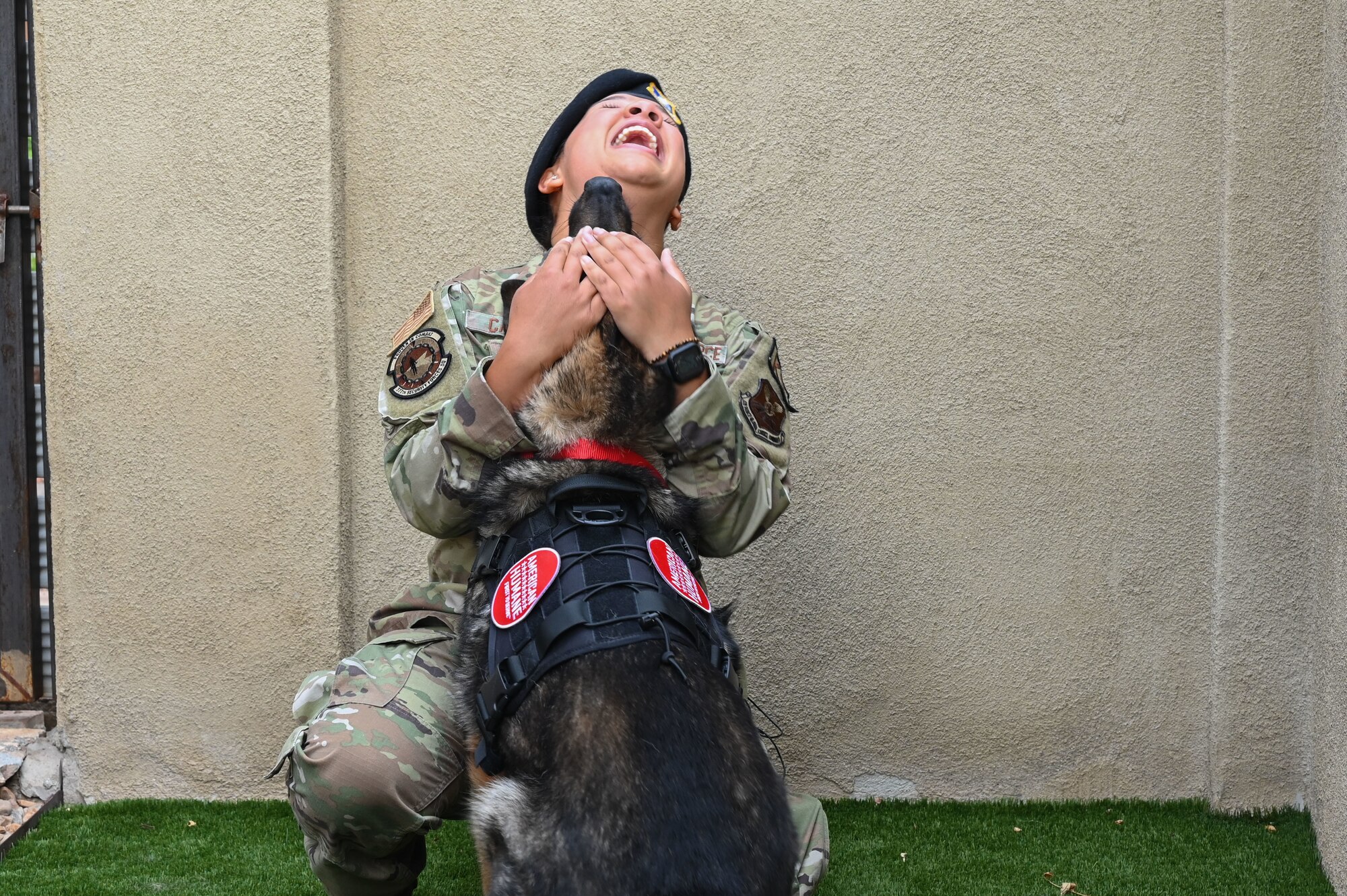 A woman hugs her dog.