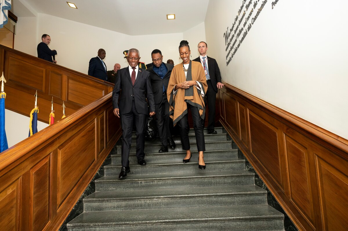 A group of people walk down steps.