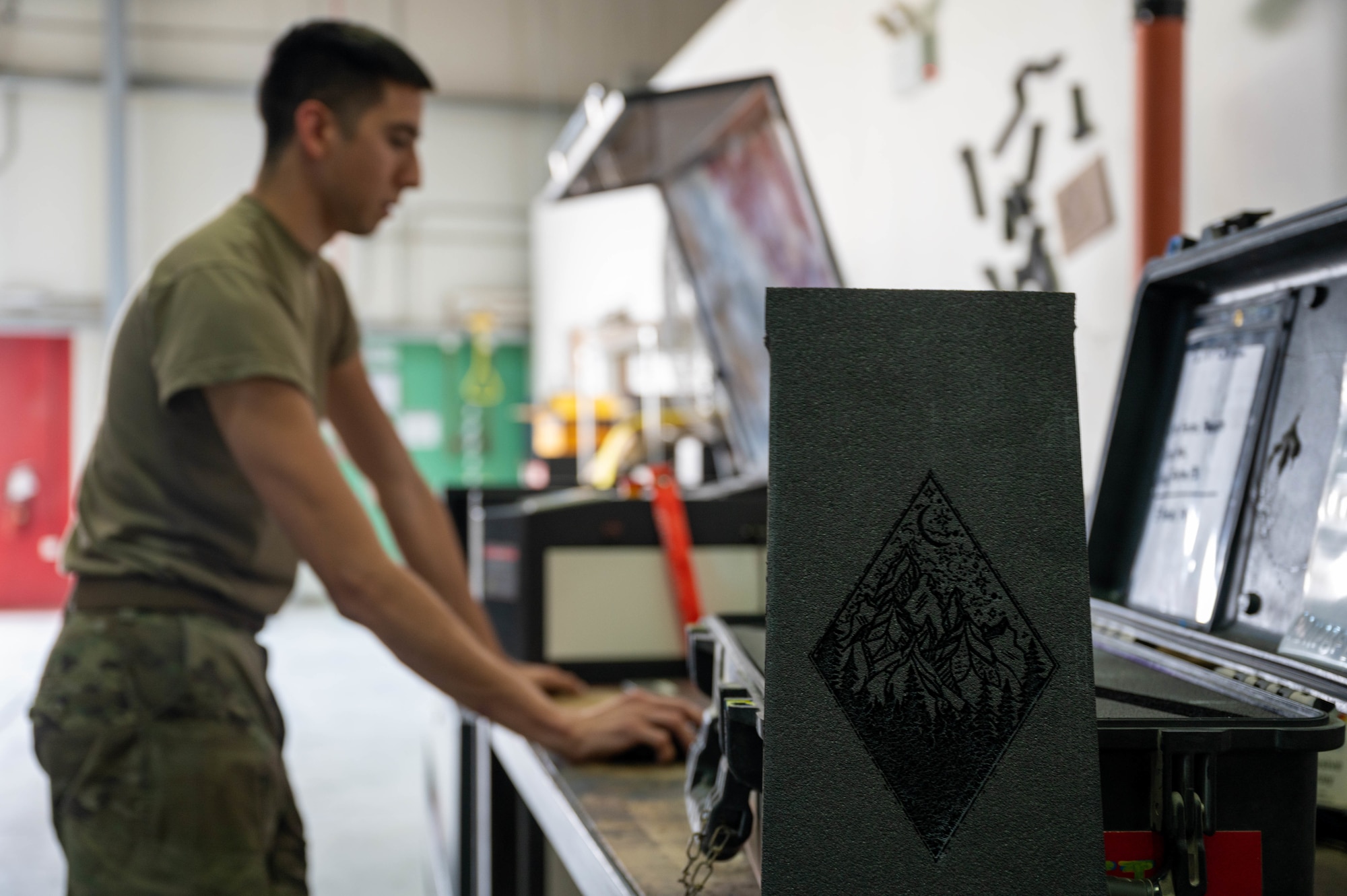U.S. Air Force Senior Airman Albert Garcia, a composite tool kit technician and crew chief with the 386th Expeditionary Aircraft Maintenance Squadron Sortie Support Component Equipment Maintenance Flight, programs a Boss Laser HP2440 to laser cut a shape out of foam at the CTK shop at Ali Al Salem Air Base, June 23, 2022. The machine cuts the outline of a tool in the foam for tool kit boxes, so that users know exactly where each tool belongs for accountability purposes. (U.S. Air Force photo by Senior Airman Natalie Filzen)