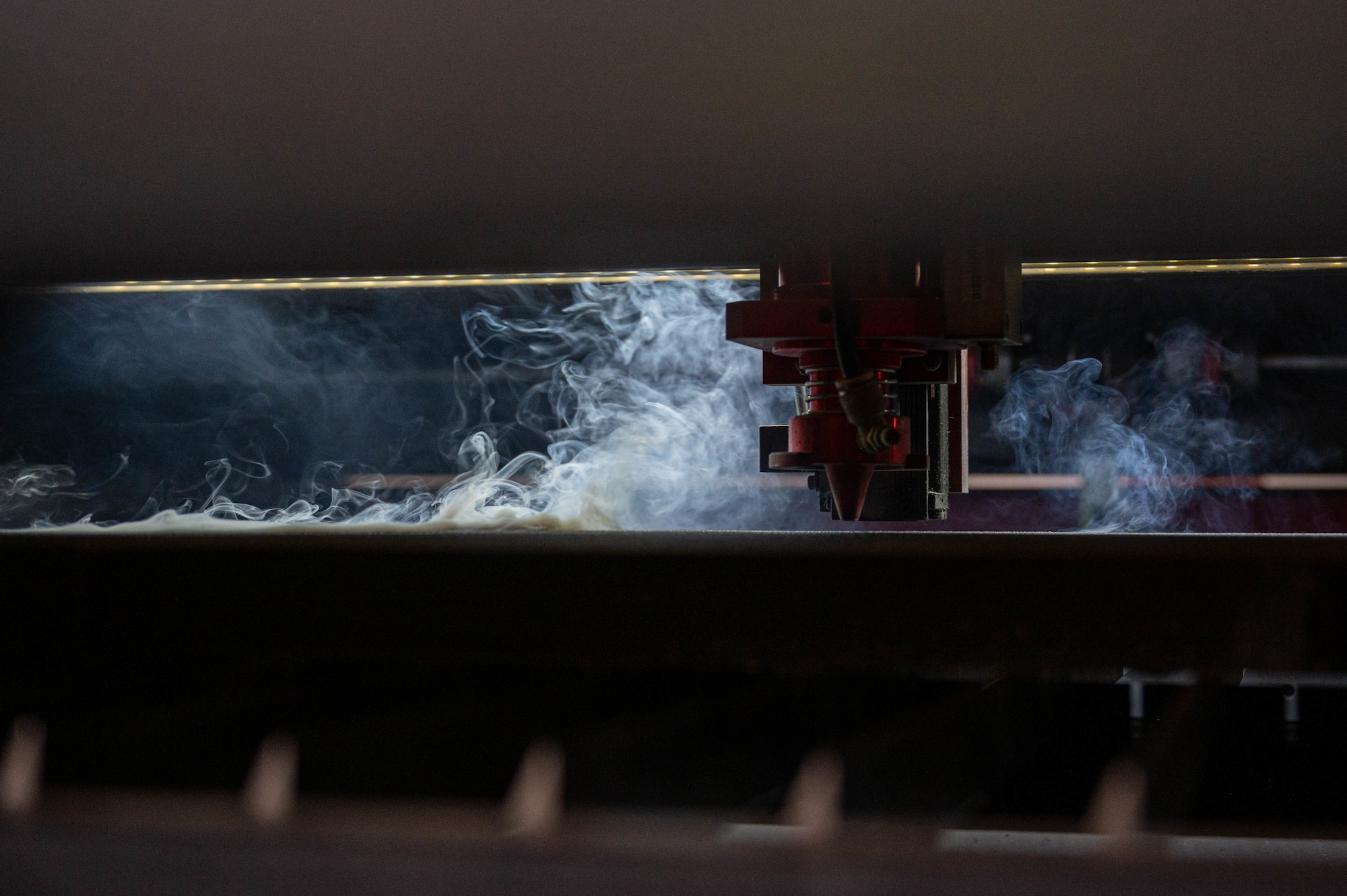 A Boss Laser HP2440 cuts a shape out of foam at the 386th Expeditionary Aircraft Maintenance Squadron Sortie Support Component Equipment Maintenance Flight shop at Ali Al Salem Air Base, June 23, 2022. The machine cuts the outline of a tool in the foam for tool kit boxes, so that users know exactly where each tool belongs for accountability purposes.  (U.S. Air Force photo by Senior Airman Natalie Filzen)