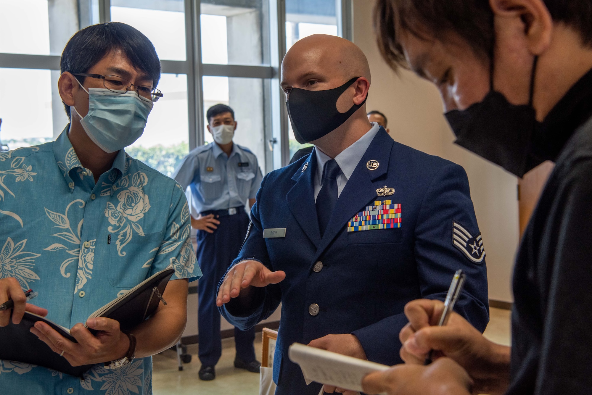 An Airman answers questions during an interview with the help of a language interpreter.