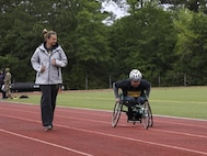 U.S. Army Staff Sgt. Jack Deleuw practices for the 100- meter wheelchair race with Team Army Coach Adriane Wilson at Army Trials May 8, 2022, at Fort Bragg North Carolina. Photo courtesy of Spc. Aleksander Fomin
