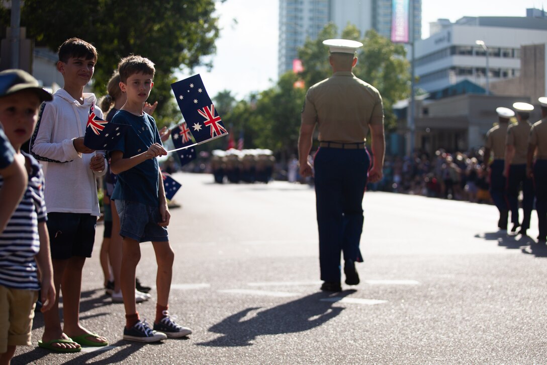 Children from Darwin, NT, Australia, watch U.S. Marines with Marine Rotational Force-Darwin (MRF-D)  22, march in a parade during the 107th Commemorative Service in honor of Australian and New Zealand Army Corps (ANZAC) Day on April 25, 2022. U.S. Marines with MRF-D 22 participated in Anzac Day ceremonies and celebrations to commemorate the first major military action fought by Australian and New Zealand forces during the First World War, and to join in recognition of the sacrifices and service of the ANZAC forces.