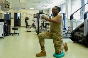 U.S. Air Force Senior Airman John Cabral, 52nd Security Forces member, performs a physical therapy exercise in the medical clinic at Spangdahlem Air Base, Germany, June 14, 2022. Providing an avenue for Airmen to rehabilitate on base helps 52nd Fighter Wing Airmen to maintain physical readiness to support worldwide Air Force operations. (U.S. Air Force photo by Staff Sgt. Chance Nardone)