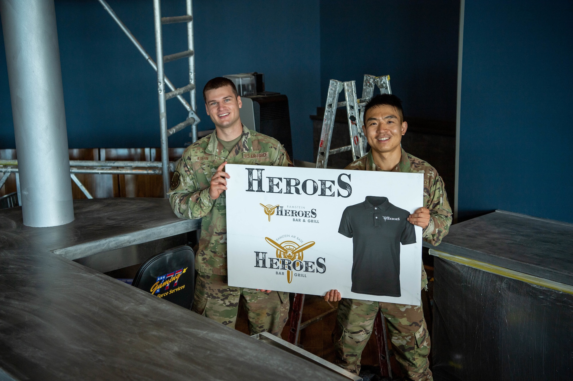 U.S. Air Force Airmen 1st Class Ruben Kuehn, left, and Airmen 1st Class Xichen Liu, right, both 786th Civil Engineer Squadron water and fuel system maintenance apprentices, aid construction of the Heroes project, July 13, 2022, at Ramstein Air Base, Germany. The Heroes project will provide Airmen and their families a spac