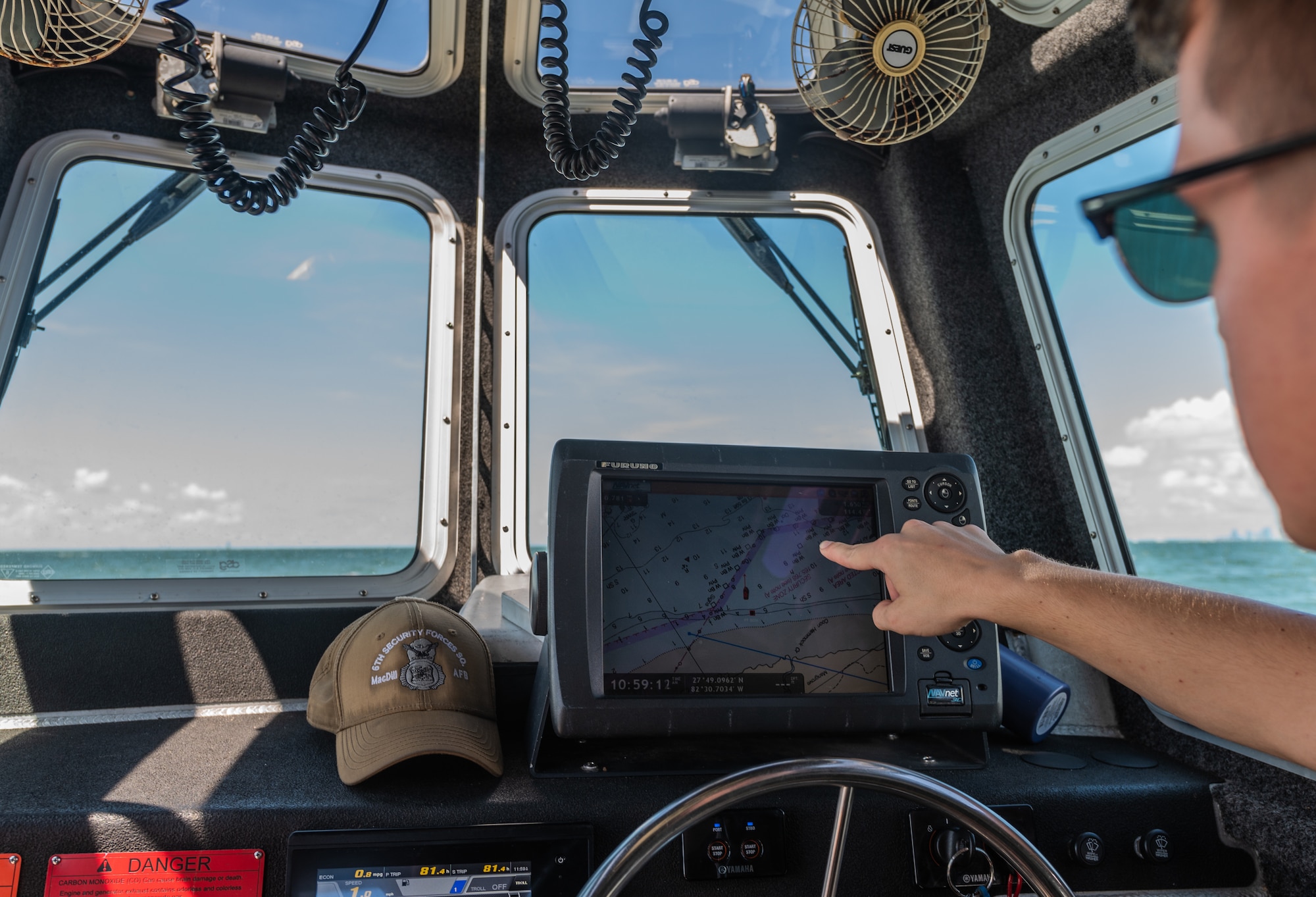 U.S. Air Force Airman 1st Class Sabin Venable, a marine patrolman assigned to the 6th Security Forces Squadron points out the rescue location on a Global Positioning System in Tampa Bay, Florida, July 10, 2022. On June 12, marine patrolmen Airman 1st Class Samari Rivera-Rodriguez, Kade Jones, and Sabin Venable, along with Staff Sgt. William Au rescued eight victims who were stranded on top of a capsized vessel in Tampa Bay while on patrol. The 6th SFS Marine Patrol unit is the only fully operational, 24/7 unit in the Air Force, and is responsible for protecting one of the largest coastal restricted areas in the Department of Defense. (U.S. Air Force photo by Staff Sgt. Alexander Cook)