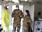 Left to right, Maj. W.A. Mustafa, South African Military Health Service dentist, speaks with counterparts from the Army Reserves and the New York Army National Guard, dentist Maj. Dwayne Bodie and dental technician Staff Sgt. Christine Iraci, July 13, 2022, outside Richards Bay, South Africa. The New York Guard members were participating in the Shared Accord exercise with their State Partnership Program partner, South Africa.