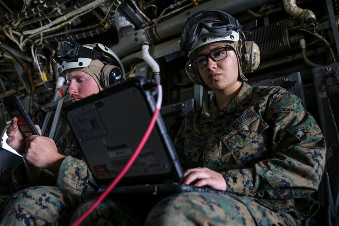 Cpl. Cecilia J. Del Rio, right, and Sgt. Louis L. Hall, network administrators with the 13th Marine Expeditionary Unit Command Element, set up a Network-On-The-Move Air system within a MV-22 Osprey tiltrotor aircraft