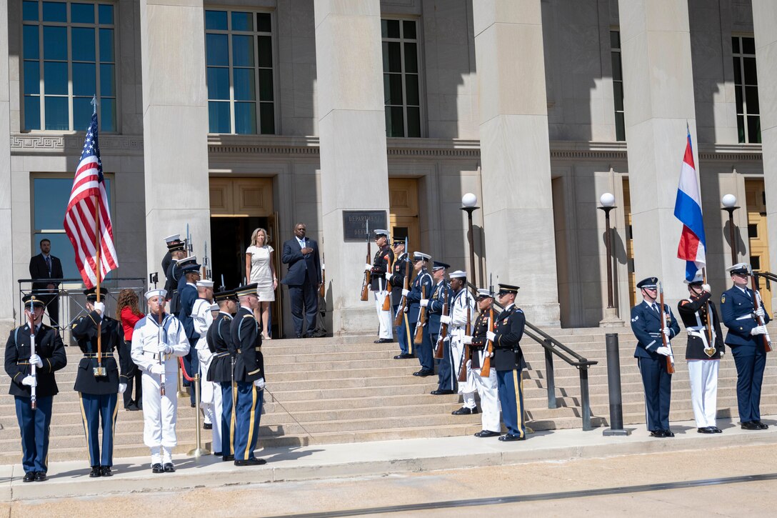 Service members render honors during a welcome ceremony for the Dutch Minister of Defense at the Pentagon.