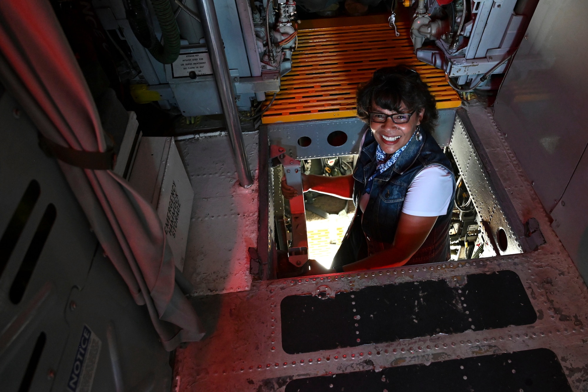 Theresa Sauls, CenterPoint Energy community relations specialist, climbs up the ladder of a B-52 Stratofortress