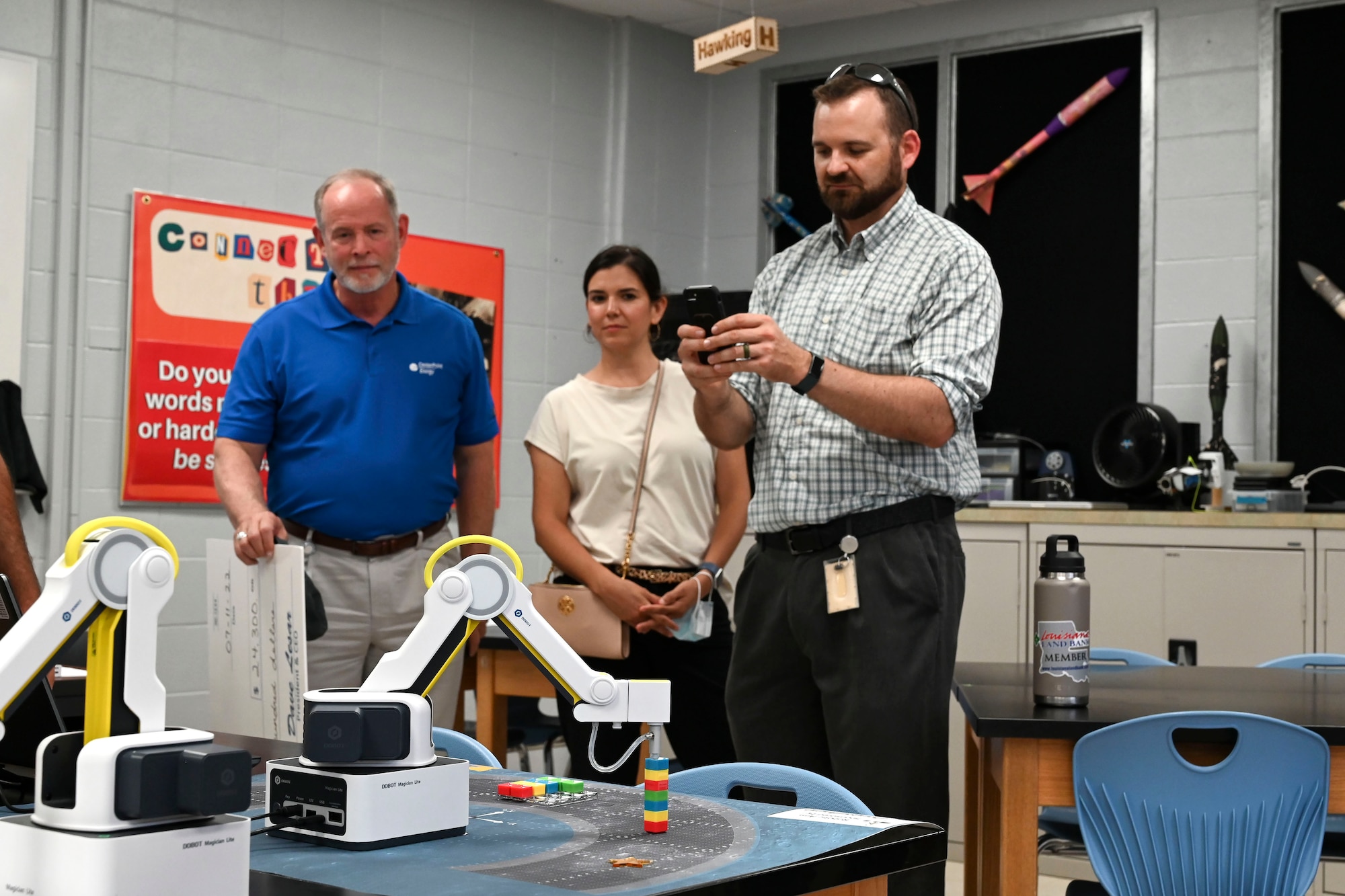 Sam Walters, CenterPoint Energy director of engineering, captures the Dobot robotic arm stacking blocks in a DoD STARBASE Louisiana classroom