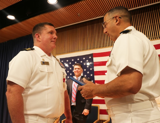 Capt. Marc Ratkus, commanding officer, Center for Information Warfare Training Center, presented Cmdr. James Brennan, former commanding officer of Information Warfare Training Command Virginia Beach, with a Meritorious Service Medal earned during his time in command at the IWTC Virginia Beach change of command ceremony held at Naval Air Station Oceana Dam Neck Annex on June 30, 2022.