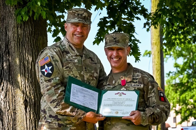 U.S. Army Maj. Gen. Mark Landes, First Army East Division commander, presents the Legion of Merit award to U.S. Army Col. Mathew Bunch, 174th Infantry Brigade commander on 13 July, 2022 at Joint Base McGuire-Dix-Lakehurst N.J. The 174th Infantry brigade is responsible for preparing soldiers of the U.S. Army Reserve and National Guard for deployment through battle training in maneuvers, equipment, and other details. (U.S. Air Force photo by Senior Airman Matt Porter)