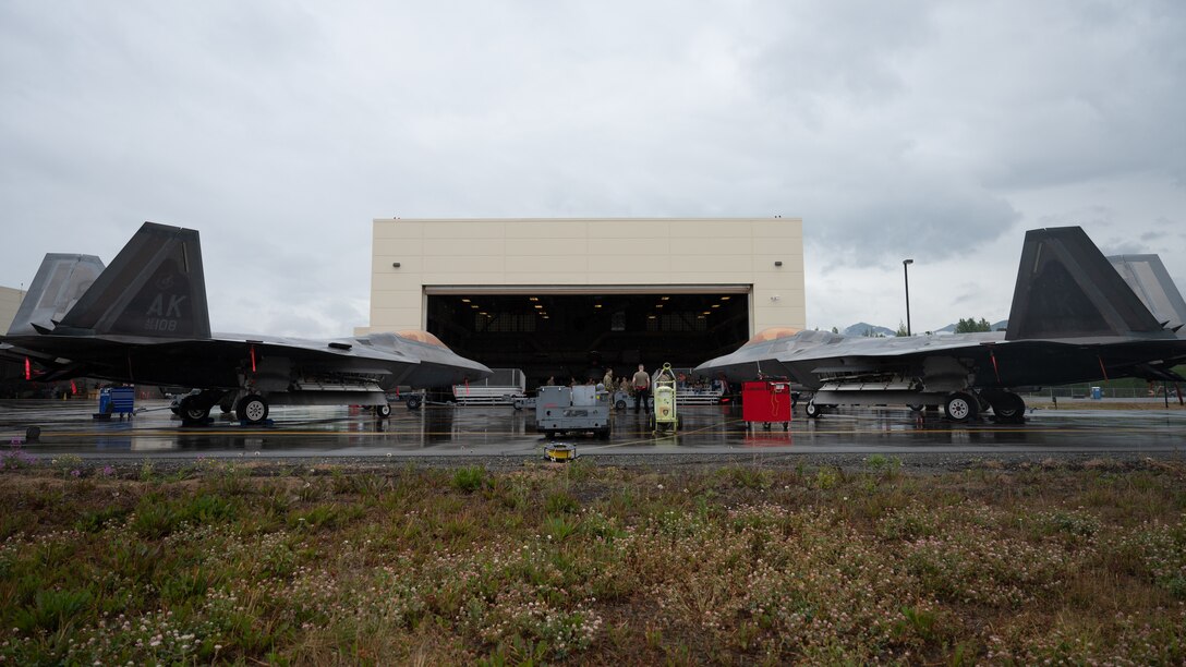 A photo of two F-22 Raptors in front of a hangar during the 3rd Wing load competition