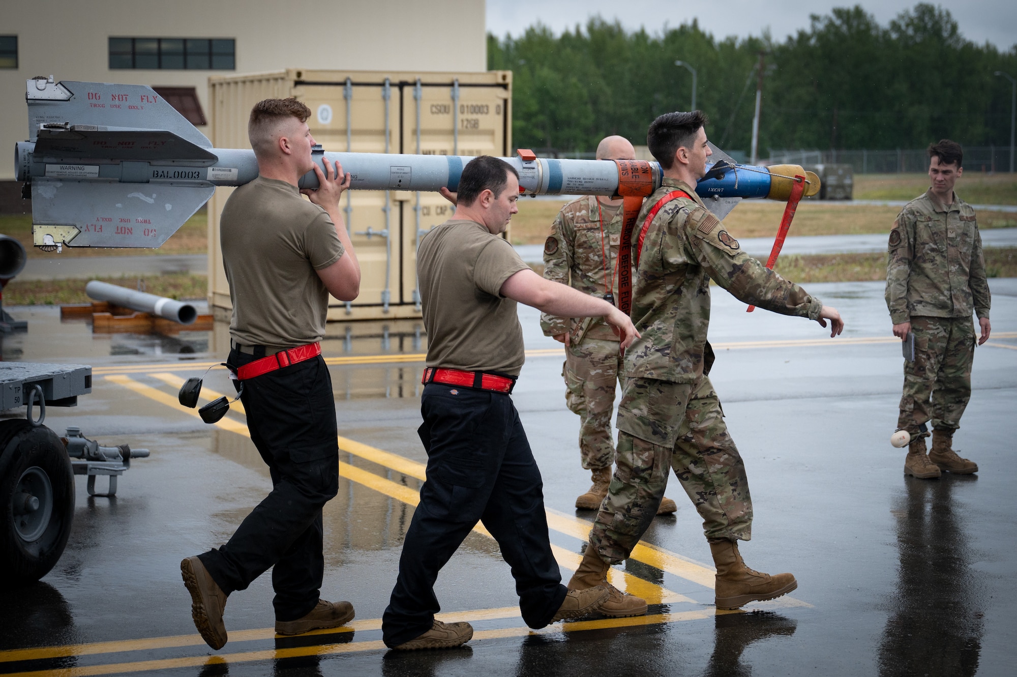 A photo of U.S. Airmen carrying a Captive Air Training Missile