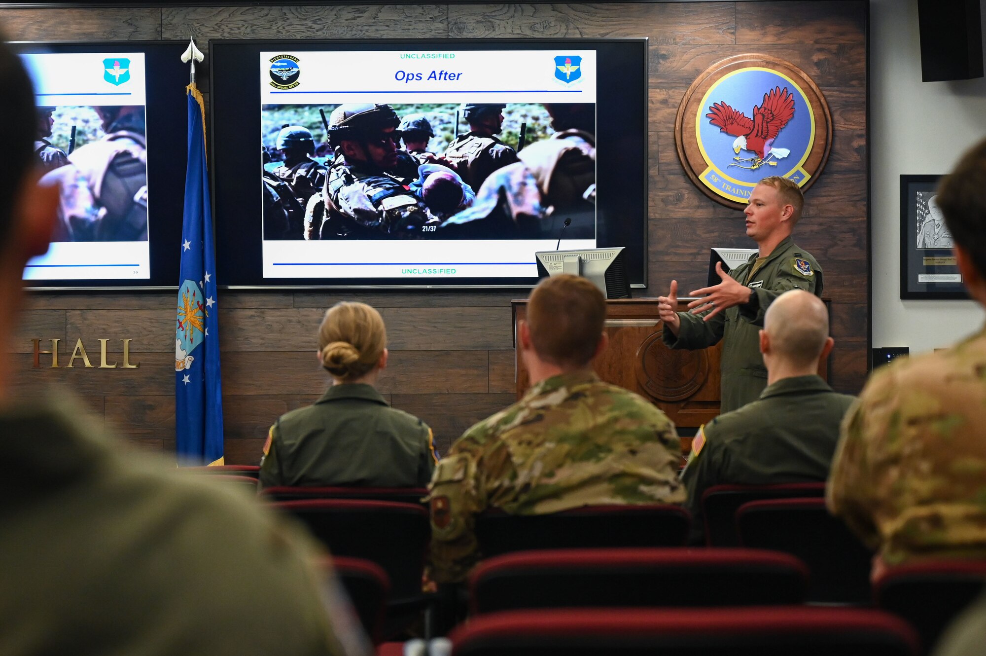 A man briefs a group of people.
