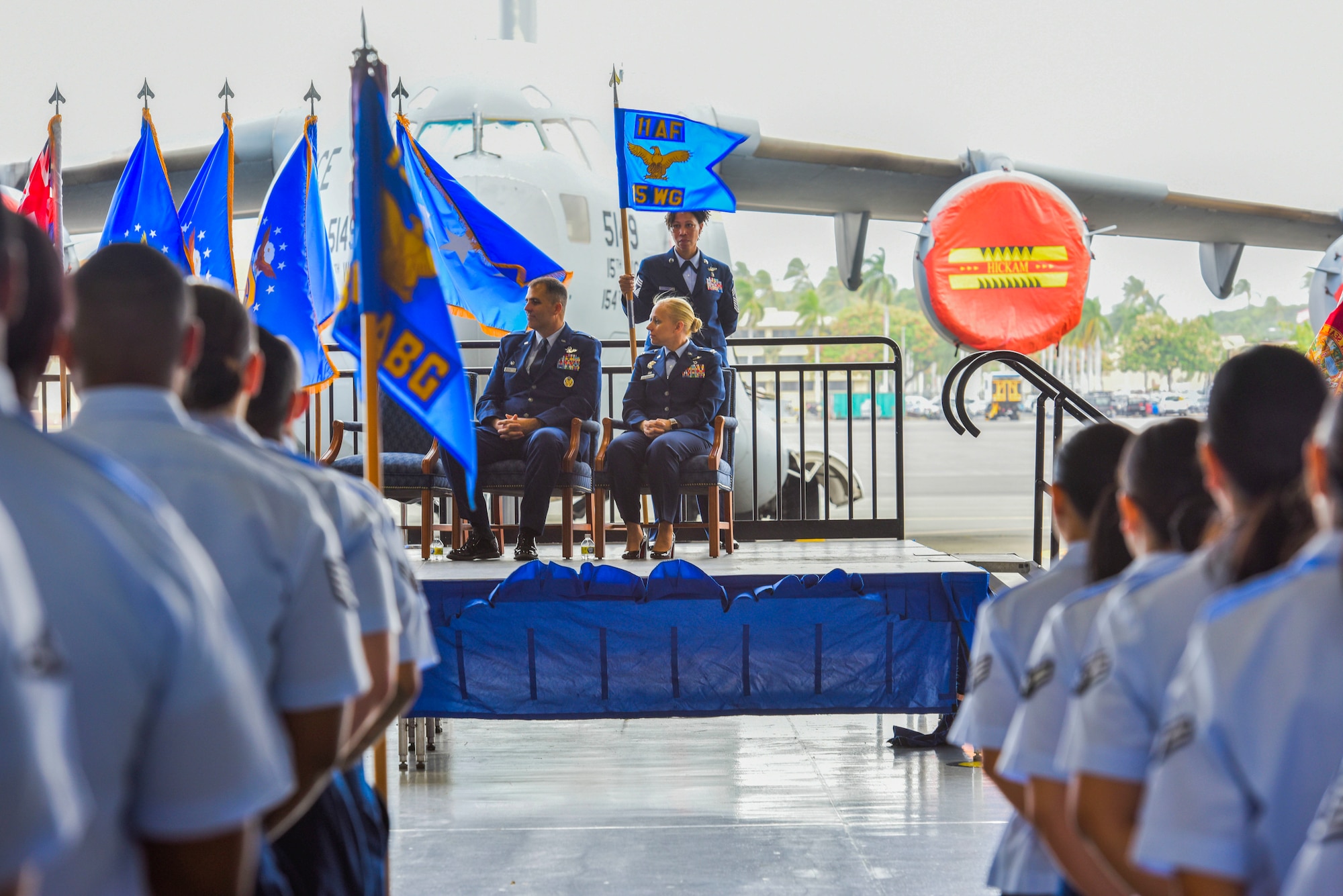 Col. Daniel Dobbels, 15th Wing commander, Col. Michele Lo Bianco, 15th Wing incoming commander, and Chief Master Sgt. Sheronne King, 15th Wing command chief, listen to a speech during the 15th Wing change of command ceremony at Joint Base Pearl Harbor-Hickam, July 8, 2022. Lo Bianco took command of the 15th Wing from Dobbels, who served 28 years in the U.S. Air Force as a command pilot with more than 3,200 flight hours and more than 600 hours of combat time. (U.S. Air Force photo by Tech. Sgt. Anthony Nelson Jr.)