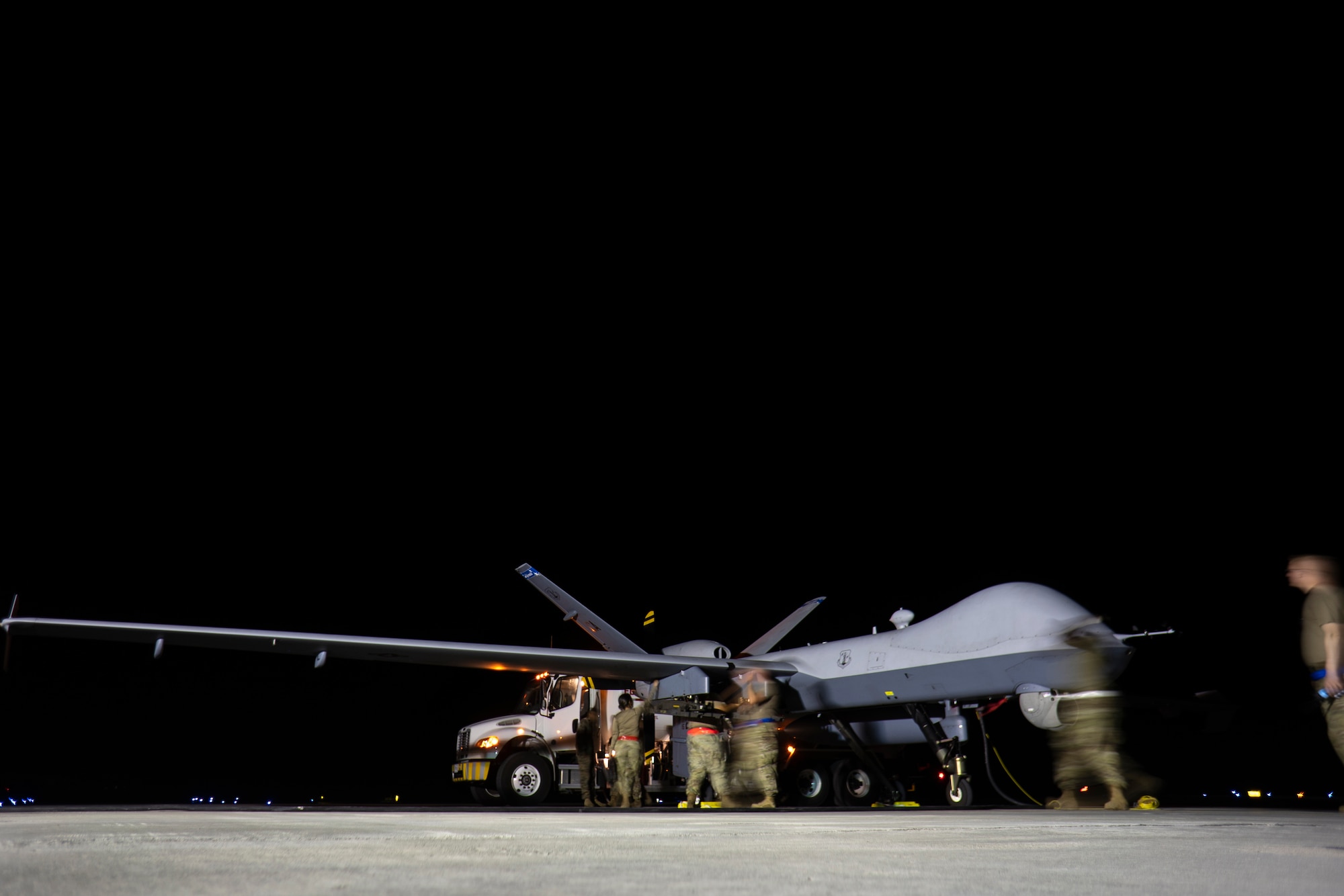 KANEOHE BAY (June 30, 2022) - U.S. Air Force maintenance Airmen from the 163d Attack Wing and 49th Aircraft Maintenance Squadron refuel an MQ-9A Reaper assigned to the 163d Attack Wing, after landing at Marine Corps Air Station Kaneohe Bay, Hawaii, during Rim of the Pacific (RIMPAC) 2022. Twenty-six nations, 38 ships, four submarines, more than 170 aircraft and 25,000 personnel are participating in RIMPAC from June 29 to Aug. 4 in and around the Hawaiian Islands and Southern California. The world’s largest international maritime exercise, RIMPAC provides a unique training opportunity while fostering and sustaining cooperative relationships among participants critical to ensuring the safety of sea lanes and security on the world’s oceans. RIMPAC 2022 is the 28th exercise in the series that began in 1971. (U.S. Air Force photo by Tech. Sgt. Emerson Nuñez)