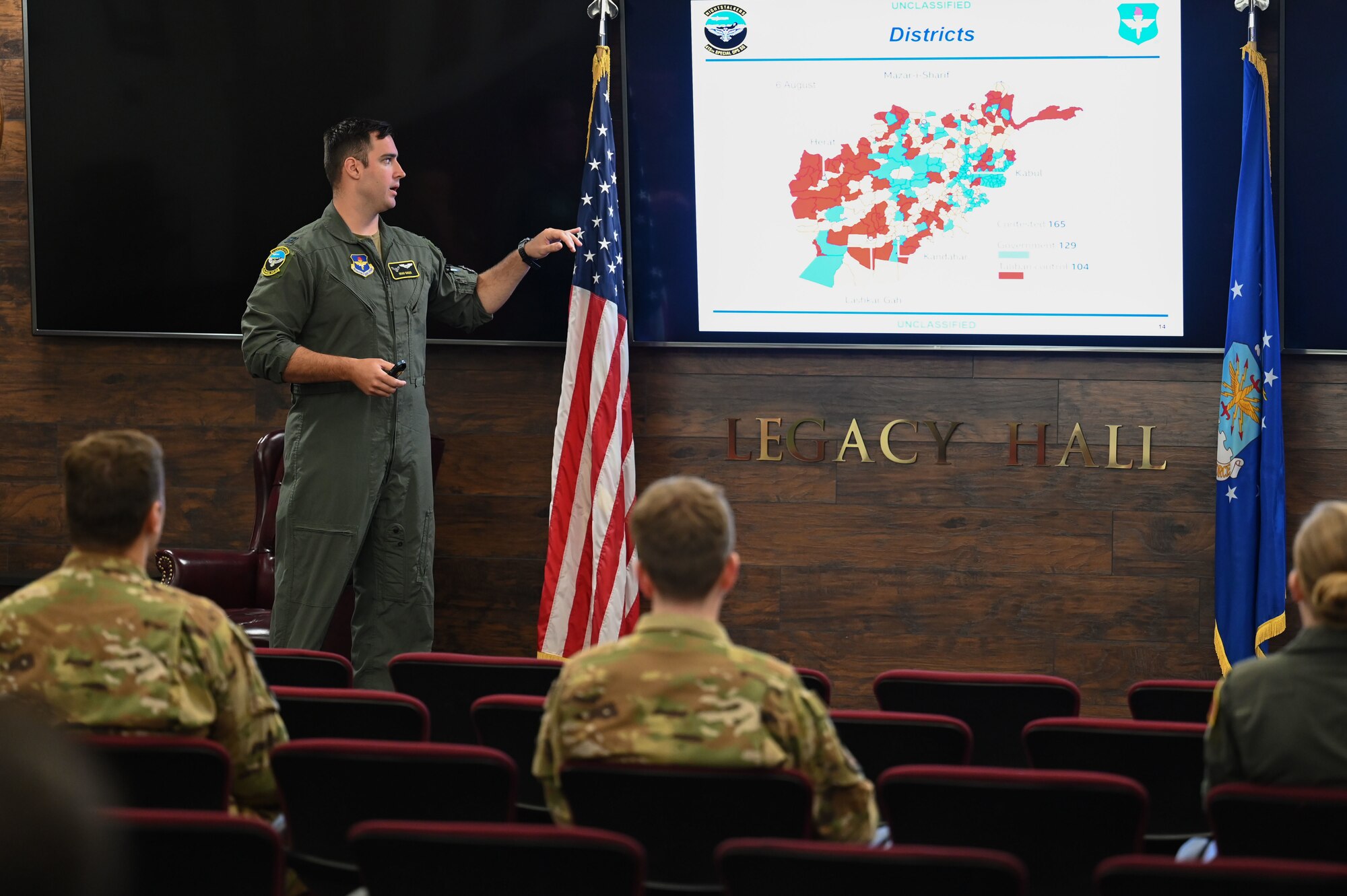 A man briefs a group of people.