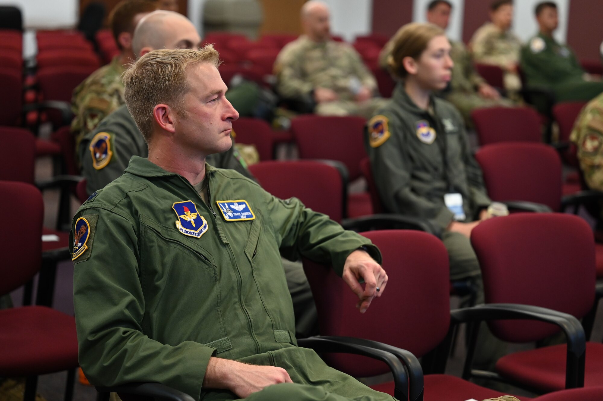 A man listens to a briefing.