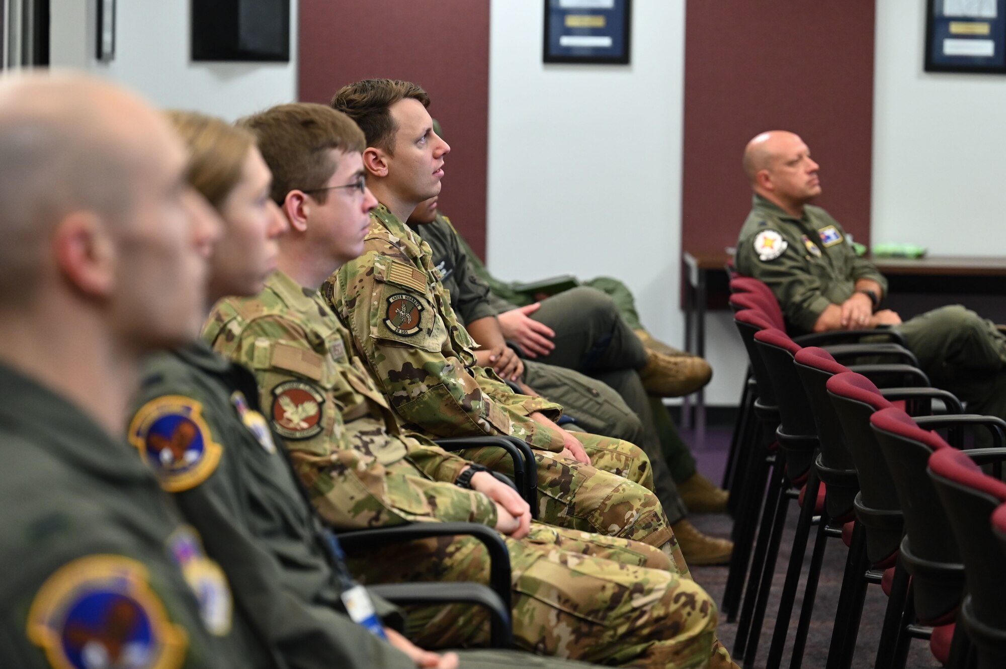 A group of people listen during a briefing.
