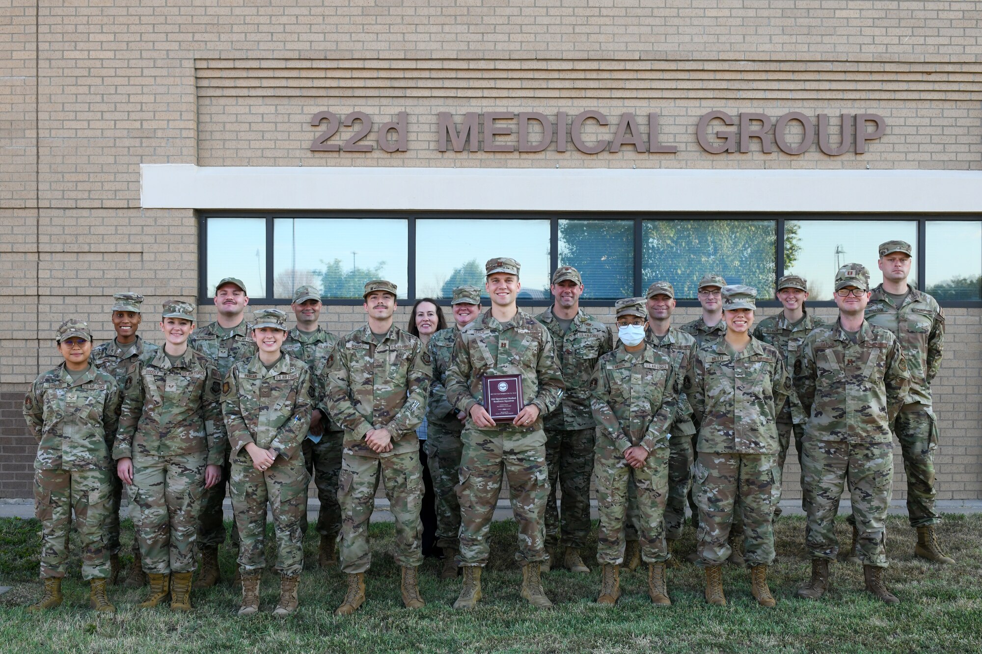Airmen from the 22nd Operational Medical Readiness Squadron pose with the Air Force Aerospace Team of the Year plaque outside of the 22nd Medical Group building, McConnell Air Force Base, Kansas, July 13th, 2022.